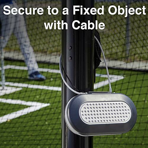 Portable lock secured to a pole with a cable near a sports field.