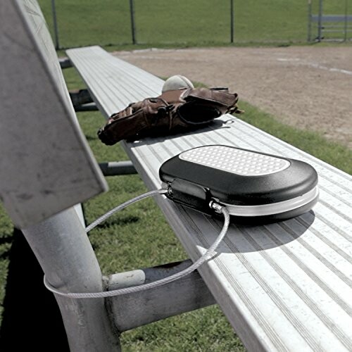 Portable safe secured on a bleacher bench with a baseball glove nearby.