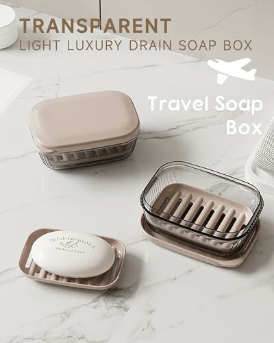 Transparent travel soap box with drain feature on marble surface